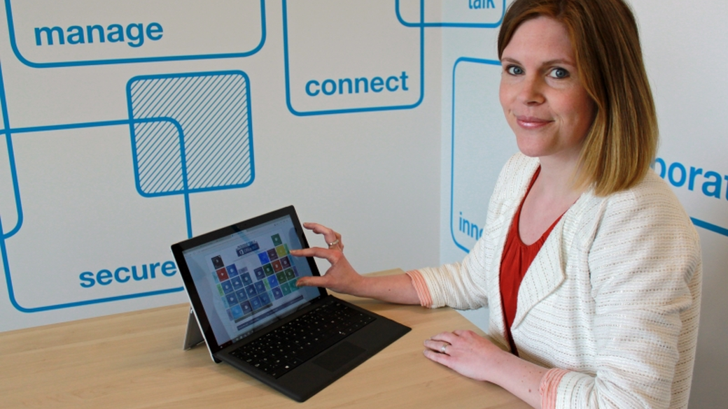 Melissa pointing at Microsoft periodic table on tablet